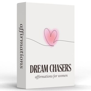 May include: A white box with the words "DREAM CHASERS" in a bold, dark font. Below, the text reads "affirmations for women." A pink heart is drawn with a single line. The word "affirmations" is printed vertically on the side of the box.