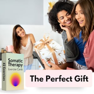 May include: A gift box wrapped in white paper with gold stars and a gold ribbon is being presented to a woman. The box is being held by another woman. The text "The Perfect Gift" is on a pink background below the image. A box of 42 Somatic Therapy Exercise Cards is shown on the left side of the image.