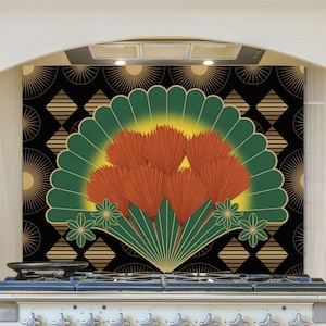 May include: A decorative kitchen backsplash featuring a fan-shaped design with orange, green, and yellow elements. The fan is set against a black background with gold geometric patterns. The backsplash is above a white stove.