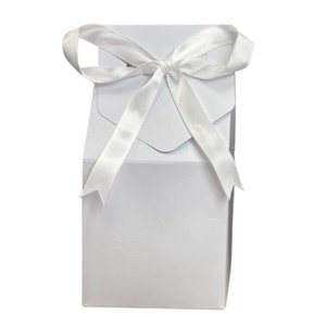 May include: A white gift box with a white satin ribbon tied in a bow.