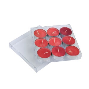 May include: A clear plastic box containing eight red tea light candles. The candles are arranged in a 3x3 grid with one candle missing from the corner.