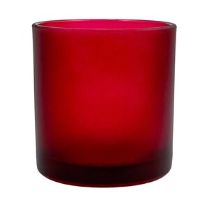 May include: A frosted red glass candle jar with a wide mouth opening. The jar is opaque and has a smooth, rounded bottom.