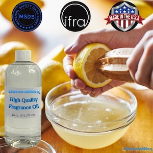 May include: A clear glass bottle with a white label that reads "GeneralWax High Quality Fragrance Oil 16 oz. (473.176 ml)". The bottle is sitting on a wooden surface with lemons and a glass bowl of lemon juice.