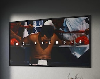 May include: A rectangular framed wall art print featuring a photograph of a boxer leaning against the ropes in a ring, wearing red boxing gloves. The text NO EXCUSES is printed in white capital letters across the center of the image.