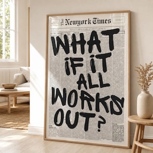 May include: A framed vertical wall art print featuring a vintage newspaper layout with the bold black hand-lettered text WHAT IF IT ALL WORKS OUT? overlaid on columns of small printed news articles, dates, and headers in a light wooden frame.