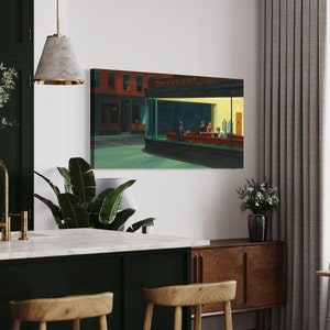 May include: A painting of a diner scene at night, with the sign "PHILLIES" above the window. There are four people sitting at the counter, and the diner is lit up with warm yellow light.