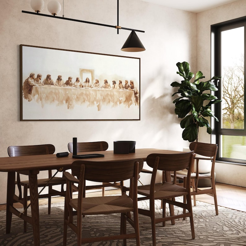 May include: A dining room scene with a wooden table and chairs. A framed artwork depicting a religious scene hangs above the table. A large potted plant is near a window, and a modern light fixture hangs from the ceiling.