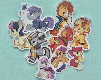 May include: A set of ten colorful cartoon pony stickers featuring a variety of poses and expressions. The stickers are printed on a white background.