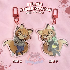 May include: Two clear acrylic dangle keychains featuring a cartoon fox character with brown fur and hair. The keychains have red hardware and the text "BTD: REN DANGLE KEYCHAIN SINGLE SIDE EPOXY" is printed at the top. One keychain is labeled "SIDE A" and the other "SIDE B".