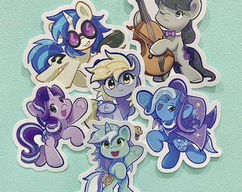 May include: A set of six colorful cartoon pony stickers featuring a variety of poses and expressions. The ponies are all wearing different outfits and accessories, including a guitar, a crown, and a flower.