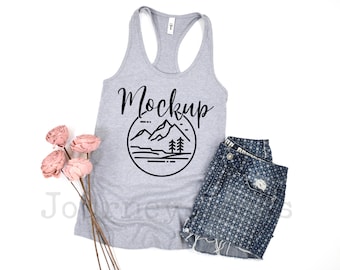 May include: Gray tank top with a black mountain range graphic and the word "Mockup" in a handwritten font.