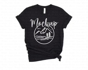 May include: Black t-shirt with a white graphic of mountains and a lake. The text "Mockup" is written above the graphic.