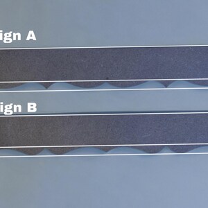 May include: Two rectangular designs labelled A and B, each with a dark grey textured surface. Design A and B are 3.8 cm wide and 1.3 cm high, with a wavy white line. The text "Design A" and "Design B" are visible.