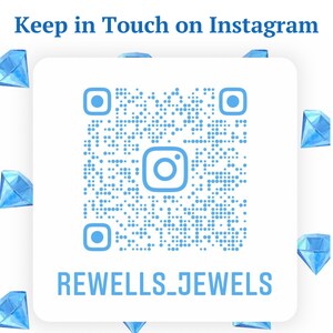 May include: A white square with a blue Instagram QR code and the text "Keep in Touch on Instagram" at the top. The QR code has a blue Instagram logo in the center. Below the QR code is the text "REWELLS_JEWELS". The background is white with blue diamond shapes around the square.