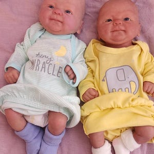 This adorable awake baby is 100% soft silicone and comes in a boy or girl or twins !  They are 15 inches long and weigh in at 3-lbs-10.6 oz