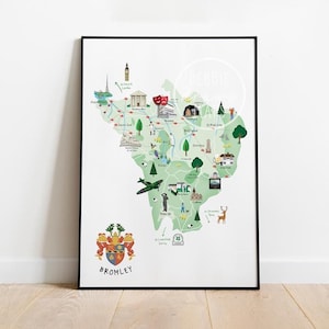 Op de afbeelding: Een ingelijste print van een kaart van Bromley, Engeland, geïllustreerd in groen met lokale bezienswaardigheden. De print bevat de naam "Debbie" en een wapenschild met het woord "Bromley" onderaan, alles in een zwart frame.