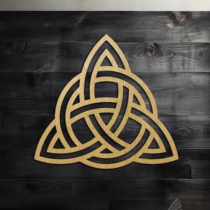 May include: A gold-coloured Celtic knot design on a dark wood background. The knot is a traditional symbol of love, friendship, and unity.
