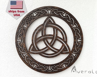 May include: A dark brown wooden wall hanging with a Celtic knot design. The knot is a triple knot, also known as a trinity knot, and is surrounded by a circular border of intricate knotwork.