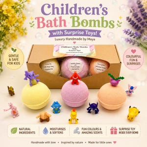 May include: A brown cardboard box containing three round bath bombs in yellow, pink, and orange. Each bath bomb is topped with a small plastic creature figure. Additional small plastic creature figures are arranged on the surface around the box.
