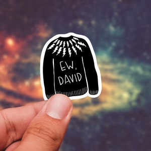 May include: A black and white sticker of a sweater with a lightning bolt pattern and the text "EW, DAVID".