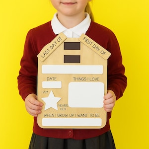 May include: A house-shaped wooden sign with the phrases "LAST DAY OF" and "FIRST DAY OF" on the top. It features spaces for "DATE", "THINGS I LOVE", "I AM", "YEARS OLD", and "WHEN I GROW UP I WANT TO BE".