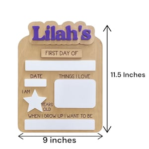 May include: A wooden sign for a child named Lilah, measuring approximately 23 cm wide and 29 cm tall. The sign has spaces for date, interests, and future goals. The name "Lilah's" is in purple letters.