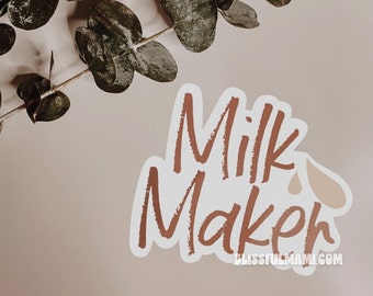May include: A white sticker with brown text that reads "Milk Maker" with a small brown drop shape to the right of the word "Milk". The text is in a handwritten style. The sticker is on a light brown background.