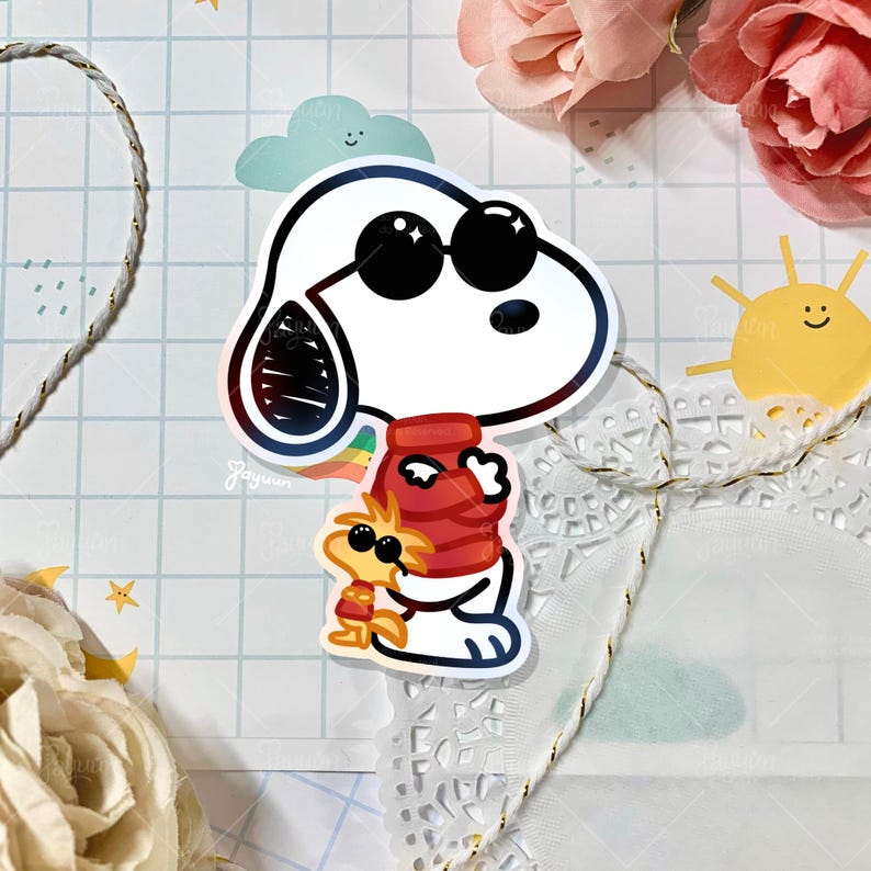 May include: A sticker featuring Snoopy wearing sunglasses, hugging Woodstock. Snoopy is white with black sunglasses, and Woodstock is yellow. Snoopy wears a red scarf, and Woodstock wears a red and yellow outfit. The sticker has a rainbow design.