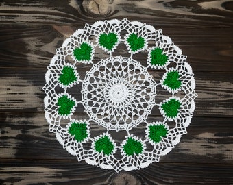 Delicate white crochet doily with green hearts. Saint Patrick's Day decor.