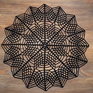 Black spider web Halloween doily. Gothic style decor.