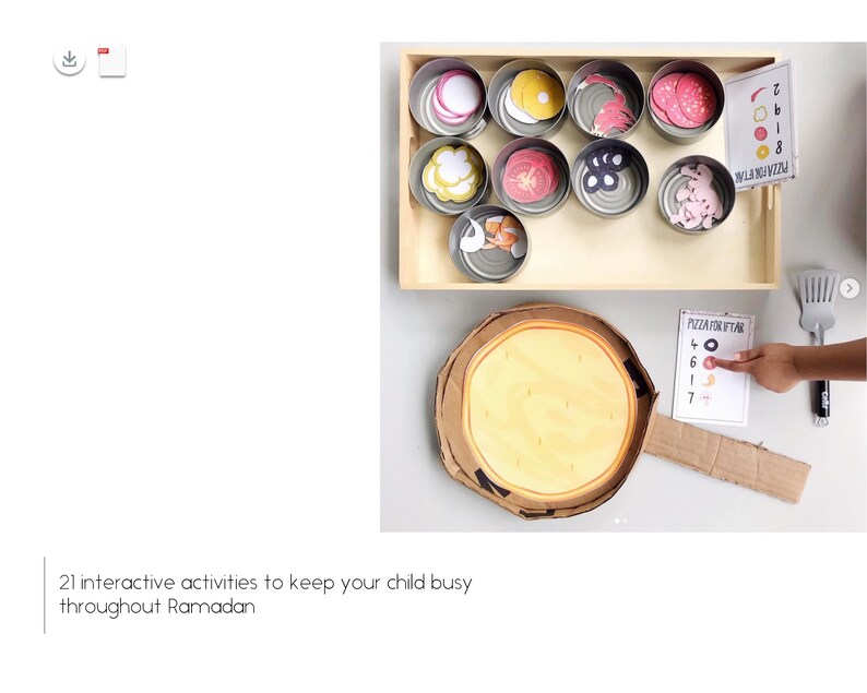 May include: A cardboard pizza box with a yellow pizza inside. There are several small cans with different toppings for the pizza. A child's hand is placing a red pepperoni topping on a card that says "Pizza for Iftar" with numbers 4, 6, 1, and 7.