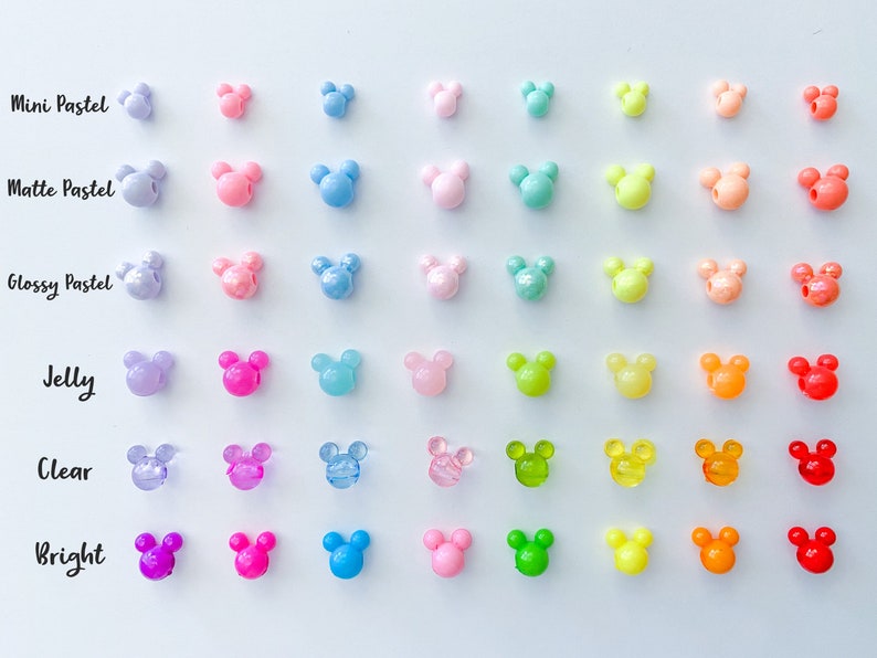 May include: A rainbow assortment of Mickey Mouse shaped beads in various finishes, including mini pastel, matte pastel, glossy pastel, jelly, clear, and bright.