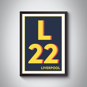May include: A framed print with a navy blue background featuring a yellow letter L and the number 22 in yellow with red outlines. The text "LIVERPOOL" is printed in white below the number.