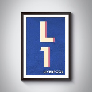 May include: A framed print with a blue background and the text "L1 LIVERPOOL" in white and pink. The "L" is a stylized letter with a pink outline and the "1" is a stylized number with a pink outline.