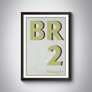 May include: A framed print with a yellow and black design. The print features the text "BR2" and "BROMLEY".