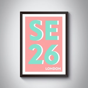 May include: A framed print with a pink background and teal text. The text reads "SE26 LONDON".