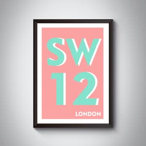May include: A framed print with a pink background and the text "SW12 LONDON" in white and turquoise letters.