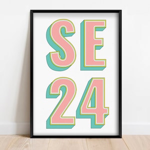 May include: A framed print with the text "SE 24" in pink letters with a green outline. The letters are in a bold, retro style.