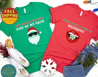 May include: Two Christmas themed t-shirts. One green t-shirt with a cartoon Santa Claus wearing sunglasses and the text "You should see the size of my sack". One red t-shirt with a cartoon red mouth with a candy cane and the text "Nice with a hint of naughty".