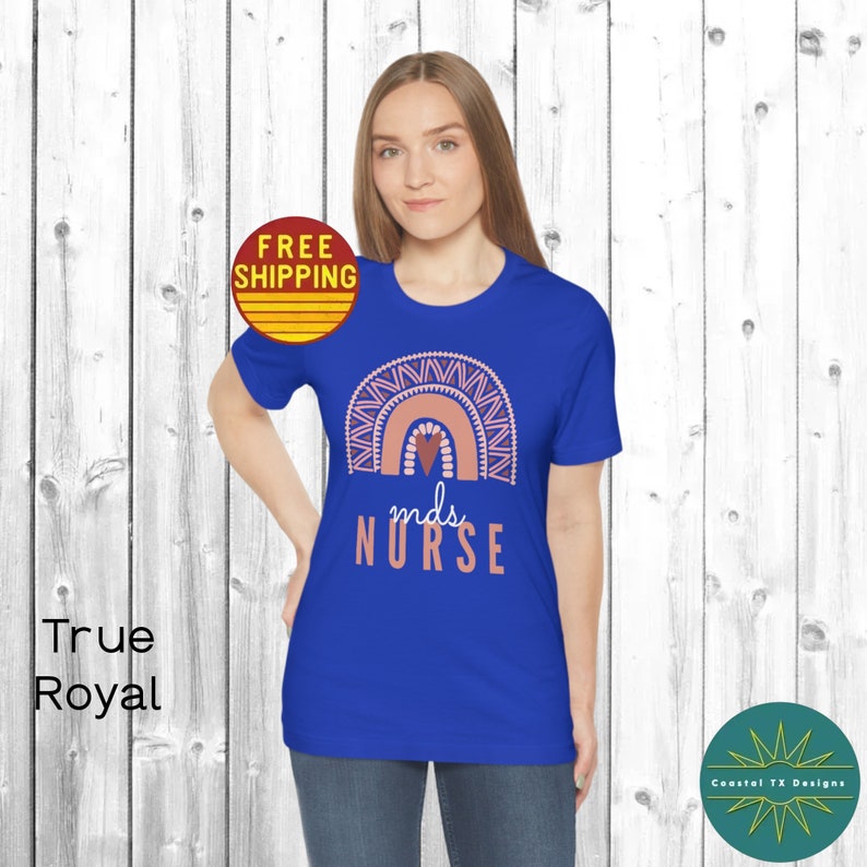May include: A royal blue t-shirt with a pink and orange rainbow graphic and the text "m.d.s. NURSE".