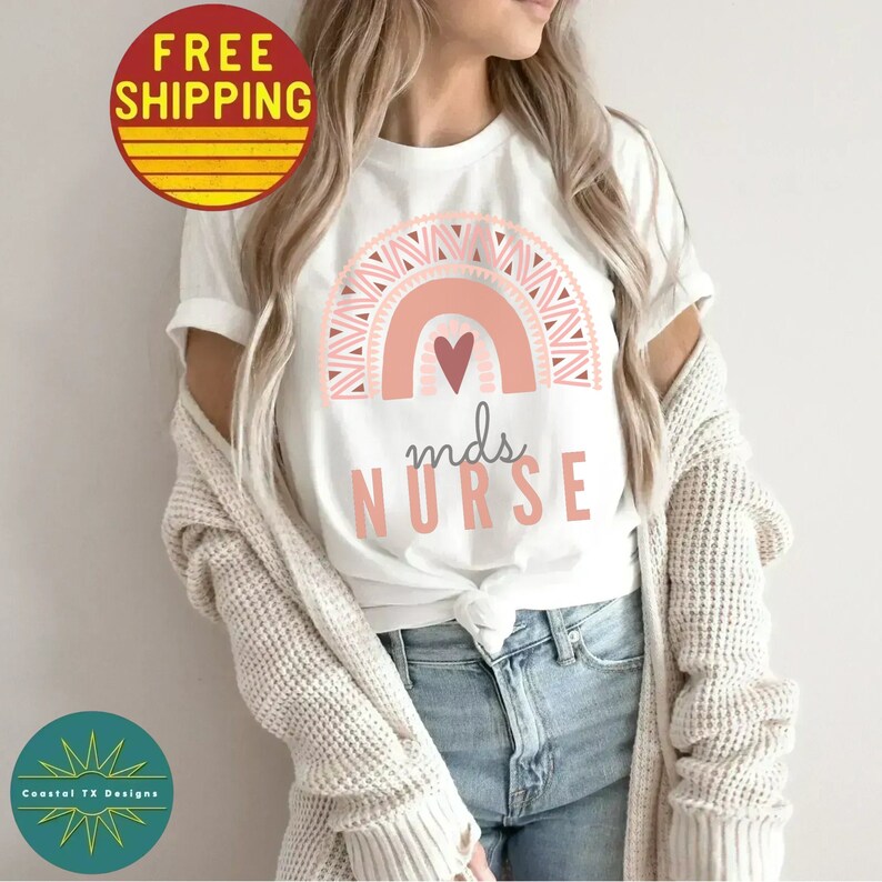 May include: White t-shirt with a pink and white rainbow design and the text "mns NURSE".