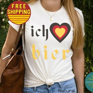 May include: White t-shirt with the text "ich &hearts; bier" in black and yellow lettering. The heart is red, yellow, and black.