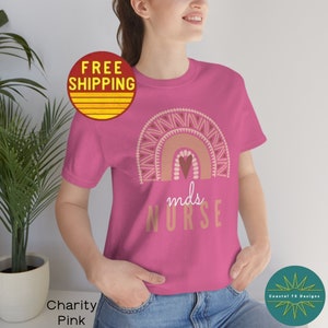 May include: Pink t-shirt with a rainbow design and the text "mds NURSE".