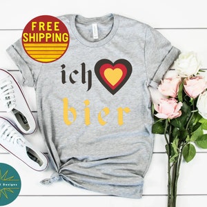 May include: Gray t-shirt with the text "ich &hearts; bier" in yellow and black. The heart is red, yellow, and black.