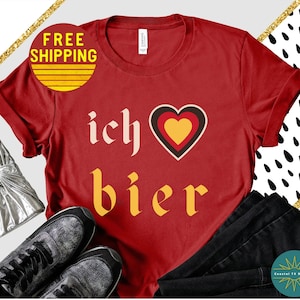 May include: Red t-shirt with the text "ich &hearts; bier" in a yellow and white font. The heart is red, yellow, and black.