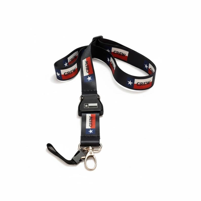 May include: Black lanyard featuring a Texas flag design. The lanyard has the Texas flag colours of red, white, and blue, with the word "CREW" printed on the strap. It has a black plastic clasp and a metal clip.