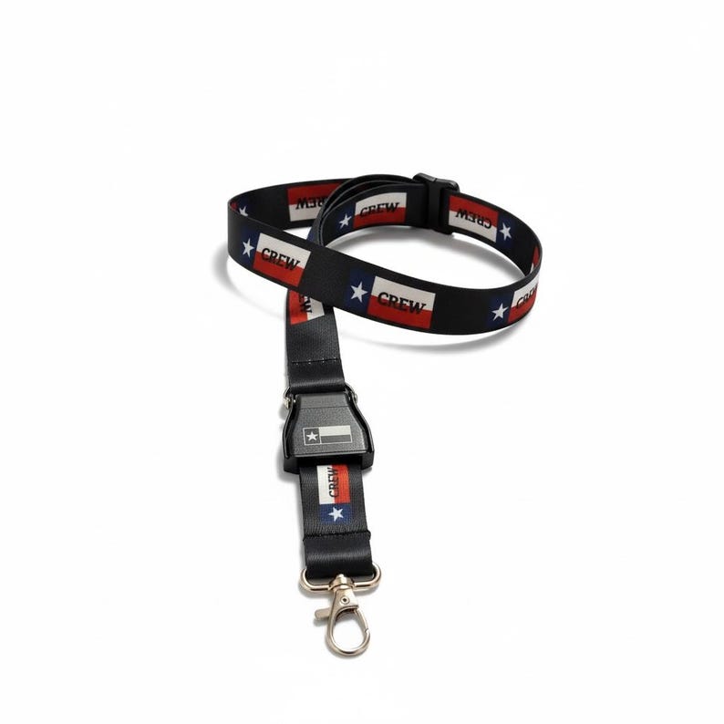 May include: Black lanyard with a Texas flag design. The lanyard features a repeating pattern of the Texas flag and the word "CREW" on a black background. It has a black buckle and a silver-coloured clasp.