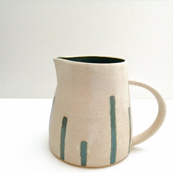 Handmade, ceramic jug with cream speckled glaze and deep moody turquoise interior