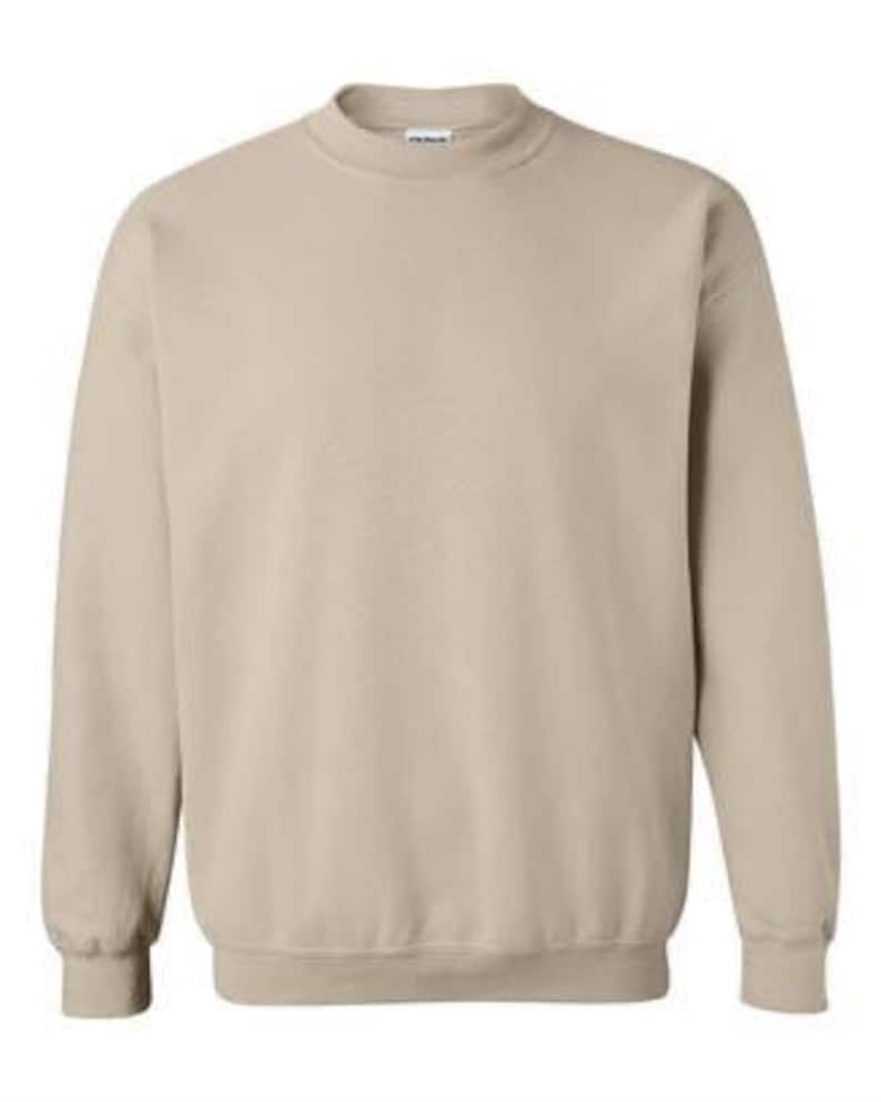 May include: A plain, light beige sweatshirt with long sleeves and a crew neck.