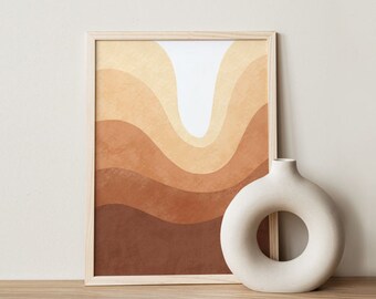 May include: A framed abstract art print with a layered, wavy design in shades of brown and beige. A white, circular vase sits beside the artwork. The frame is light-colored wood, and the background is a neutral tone.